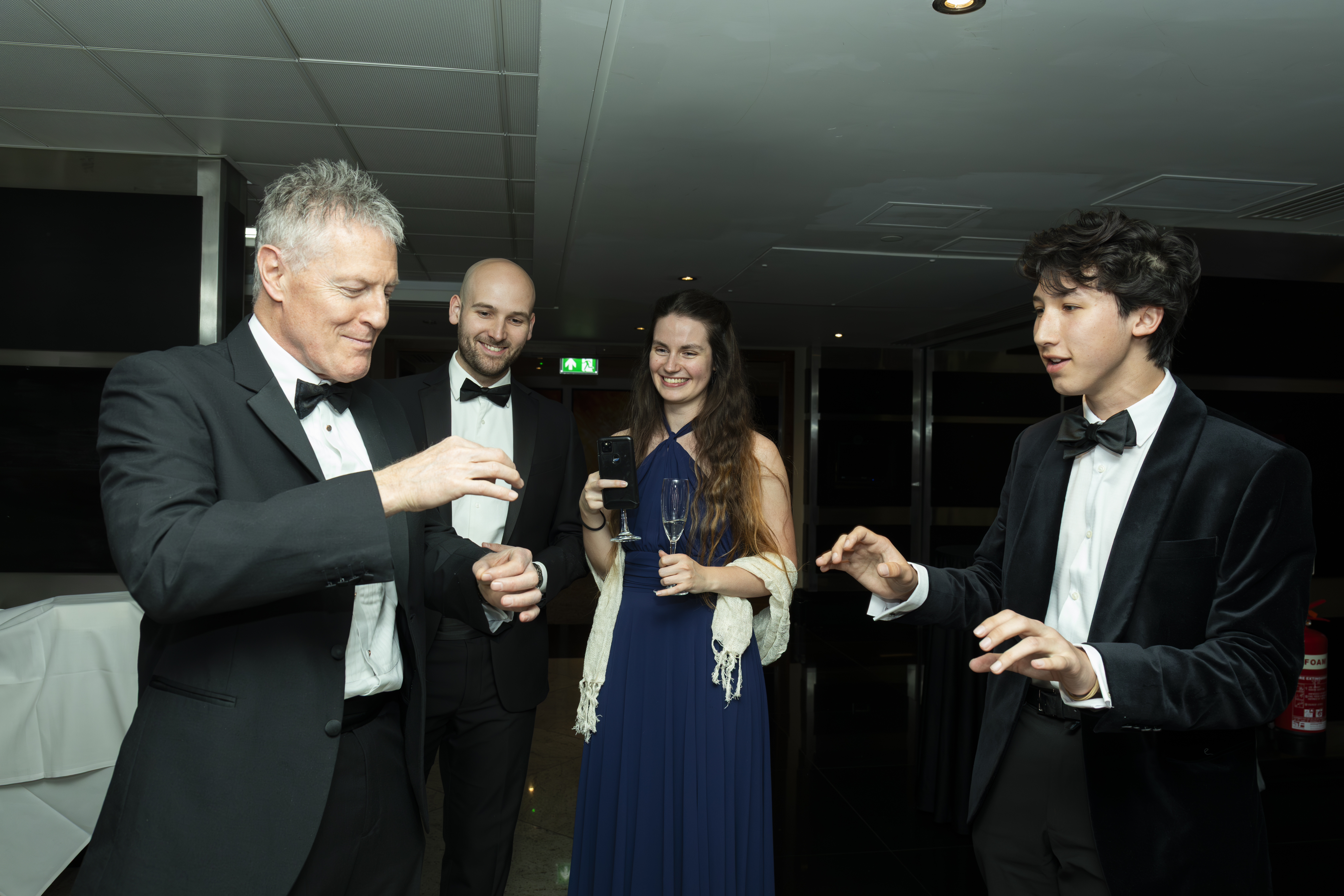Guests enjoying close-up magic at a private event